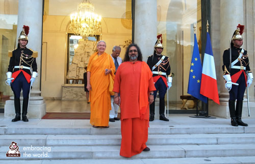 Swamiji on the steps of the event with French police behind him