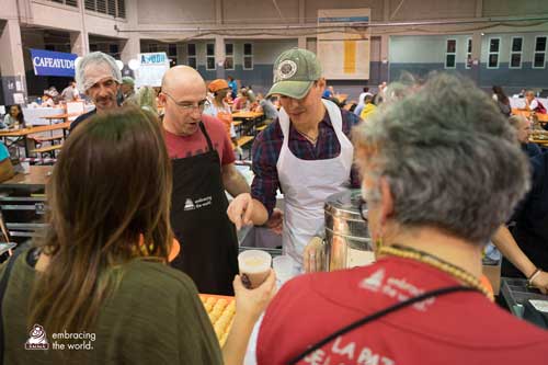 Man serves chai while volunteering