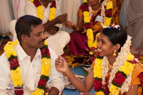 A couple perform marriage ceremony