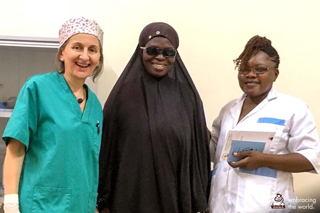 Dr. Isabel stands with local nurse and patient dressed in a burka