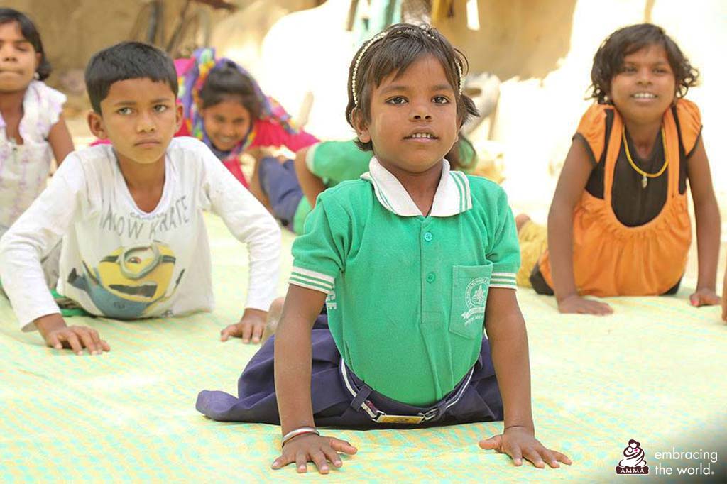 Children practice yoga