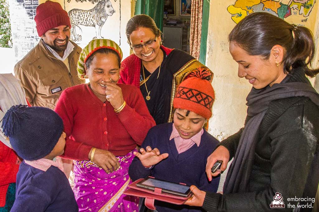 Villagers stand around tablet and smile