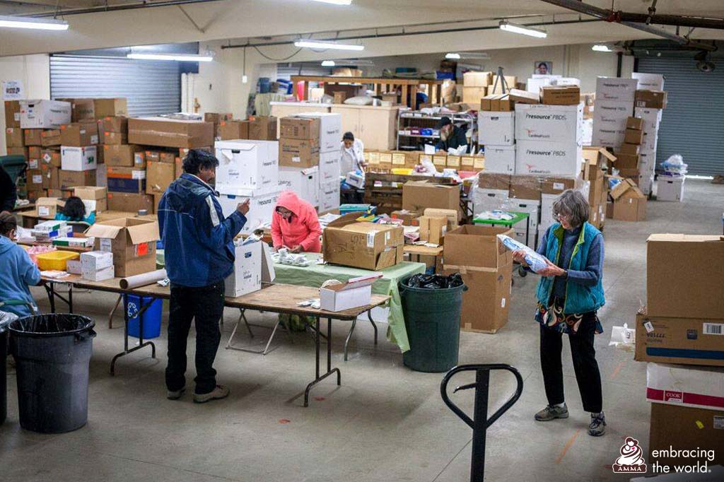 A warehouse full of boxes and people working with clipboards