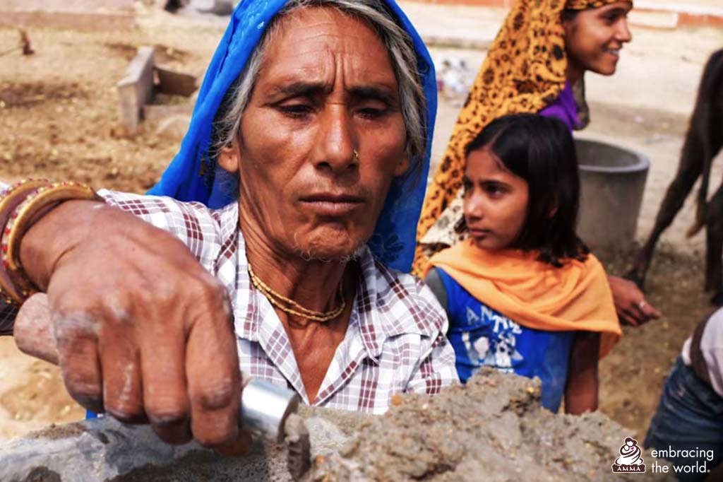 A woman in Rajastan lays cement