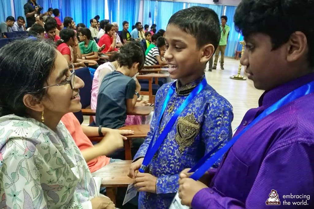 Gayathri speaks with two of the students