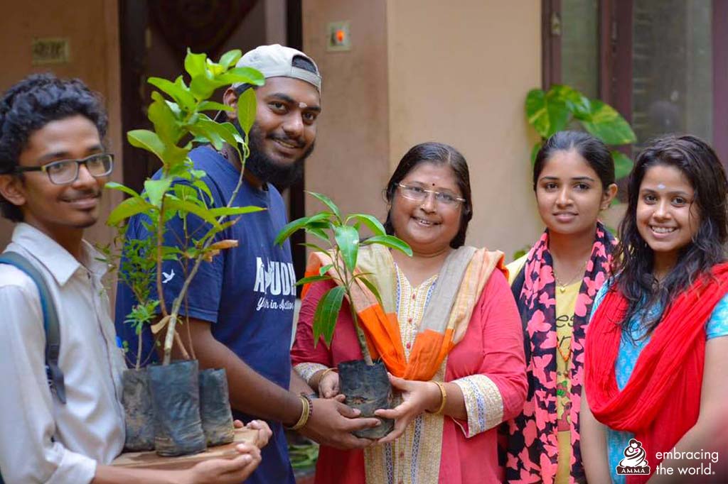 A family receives a sapling from ayudh members