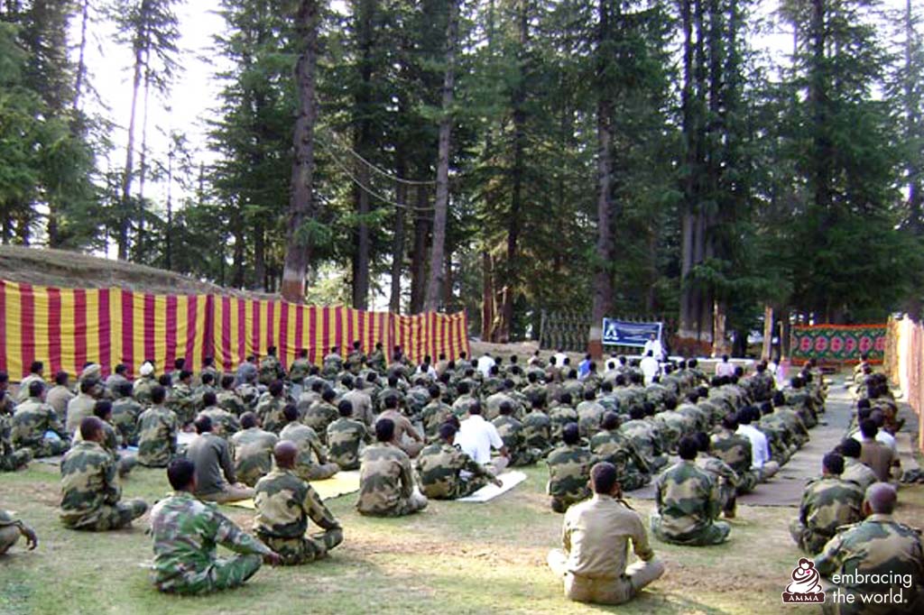 Hundred of soldiers sit outside and learn to meditate