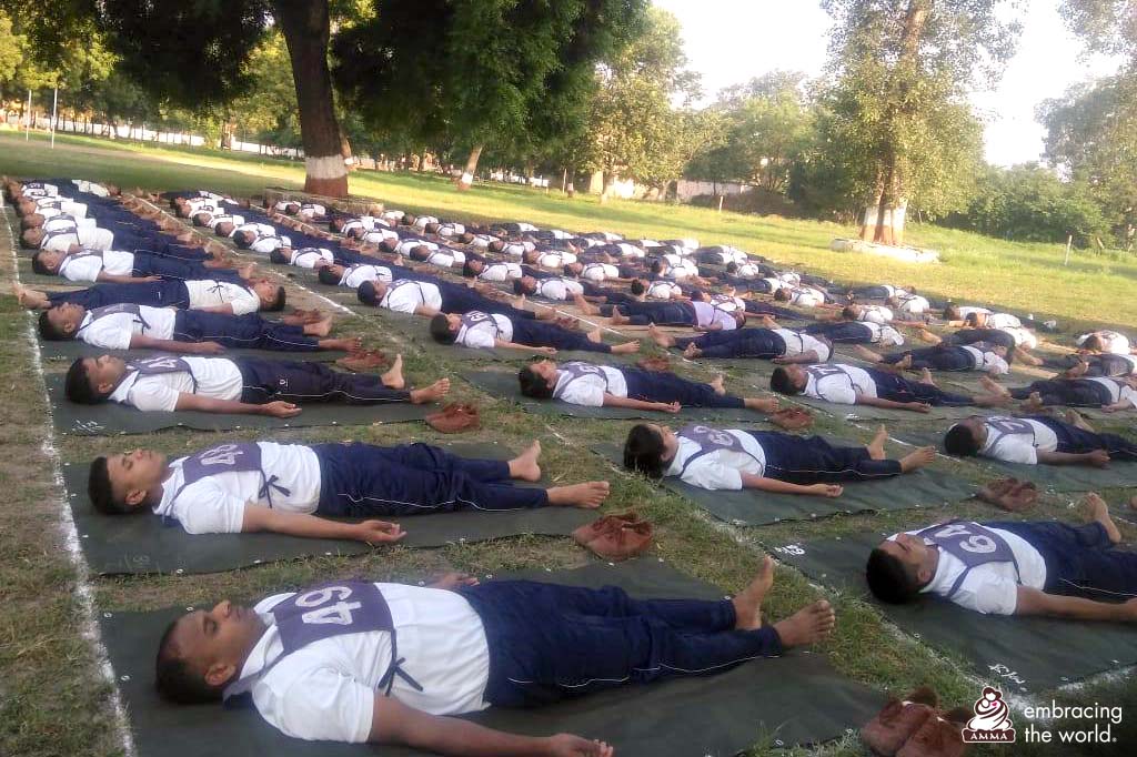 Police lay on the ground in savasana, final relaxation pose