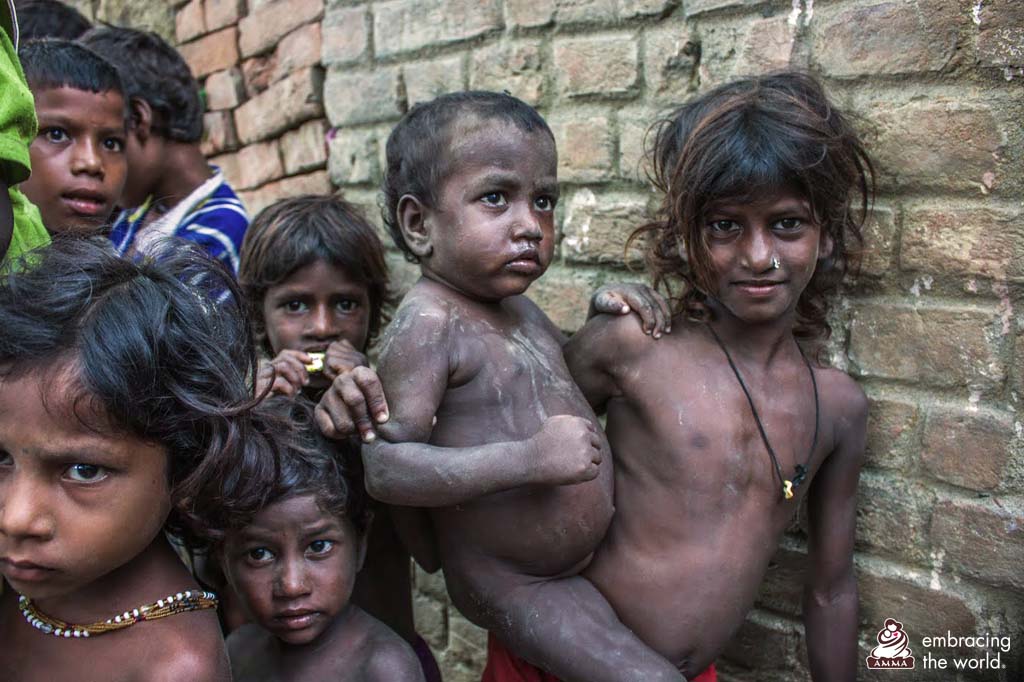 A group of children stand without clothes 