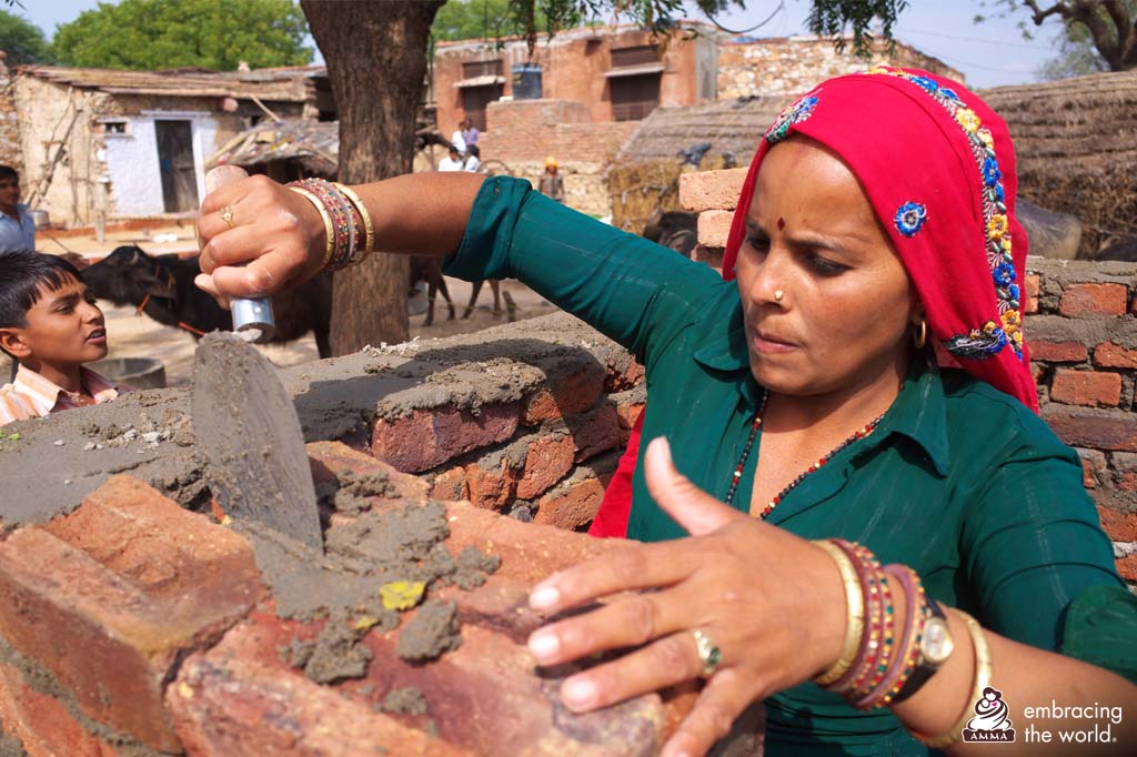Women construct toilets by hand