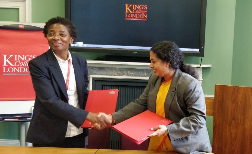 Prof. Funmi Olonisakan and Dr. Maneesha Sudheer holding their copies of the MoU