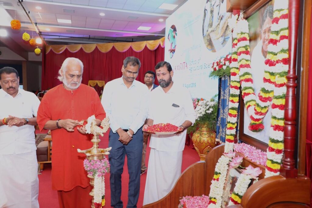 Swami Ramakrishnananda lights lamp