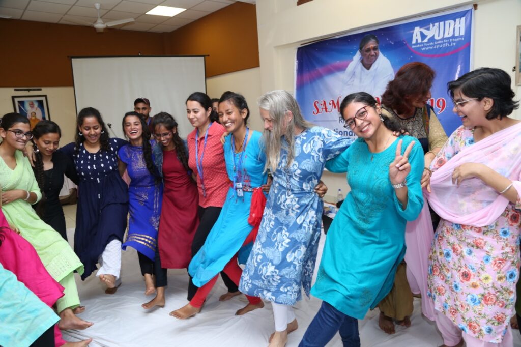 female students dancing in a line arm in arm