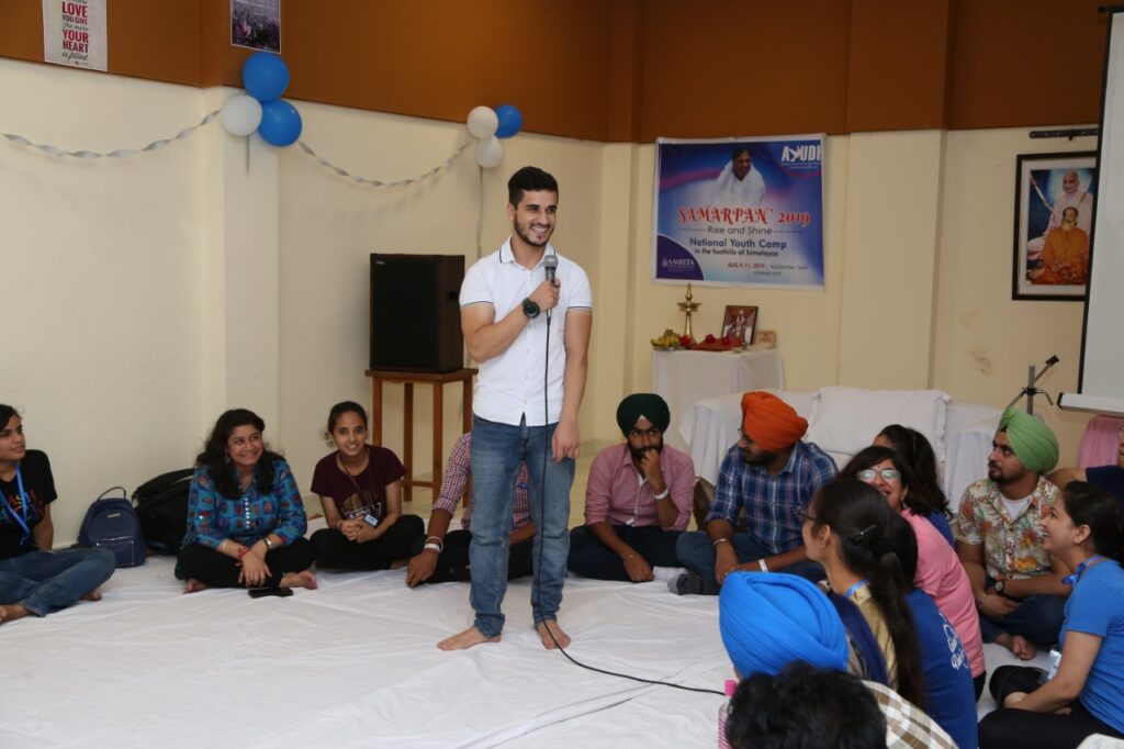 students seated around a man giving a talk