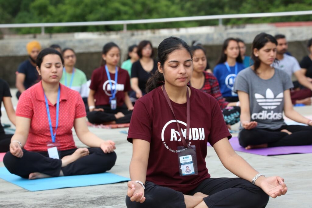 attendees seated in lotus position on mats