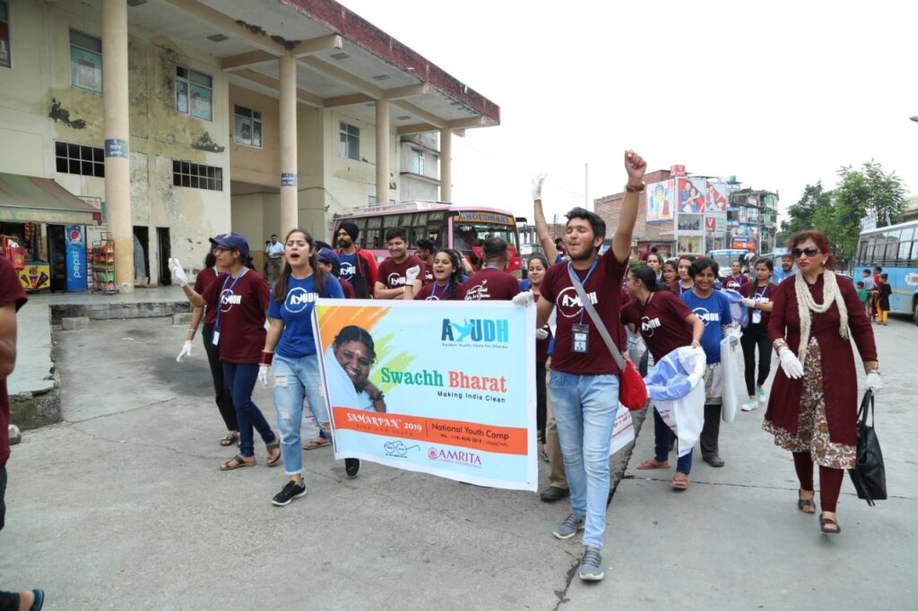 students walking through the village holding a banner