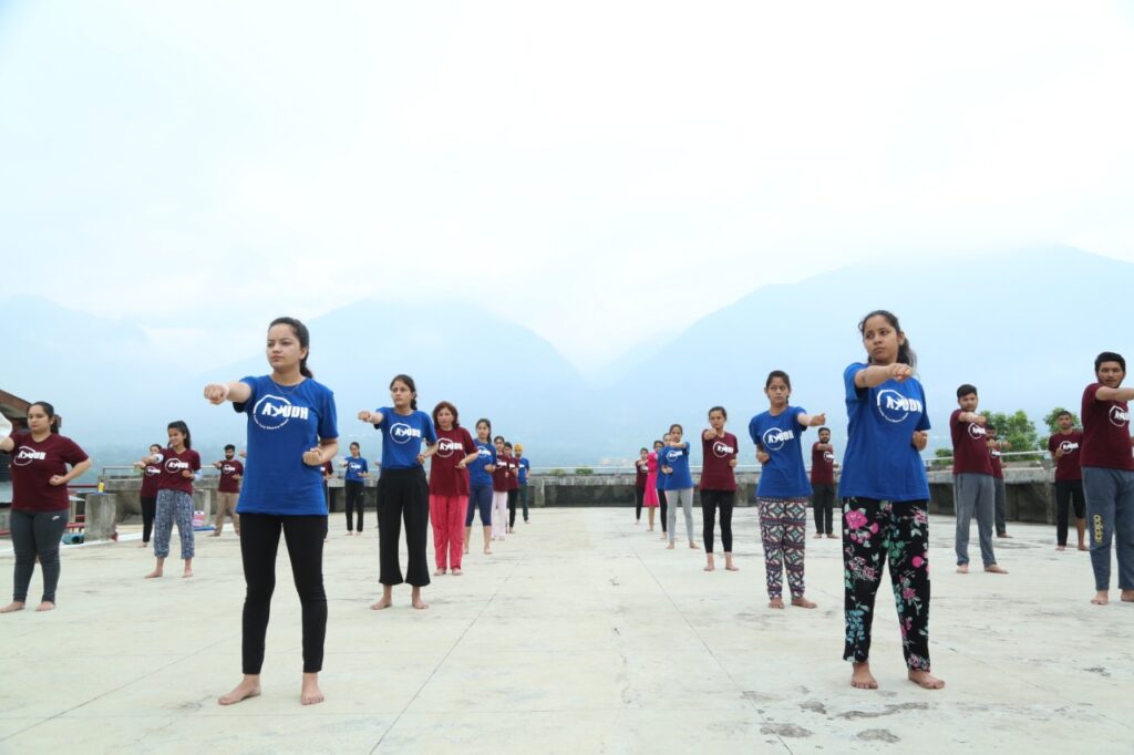 students standing practicing karate poses