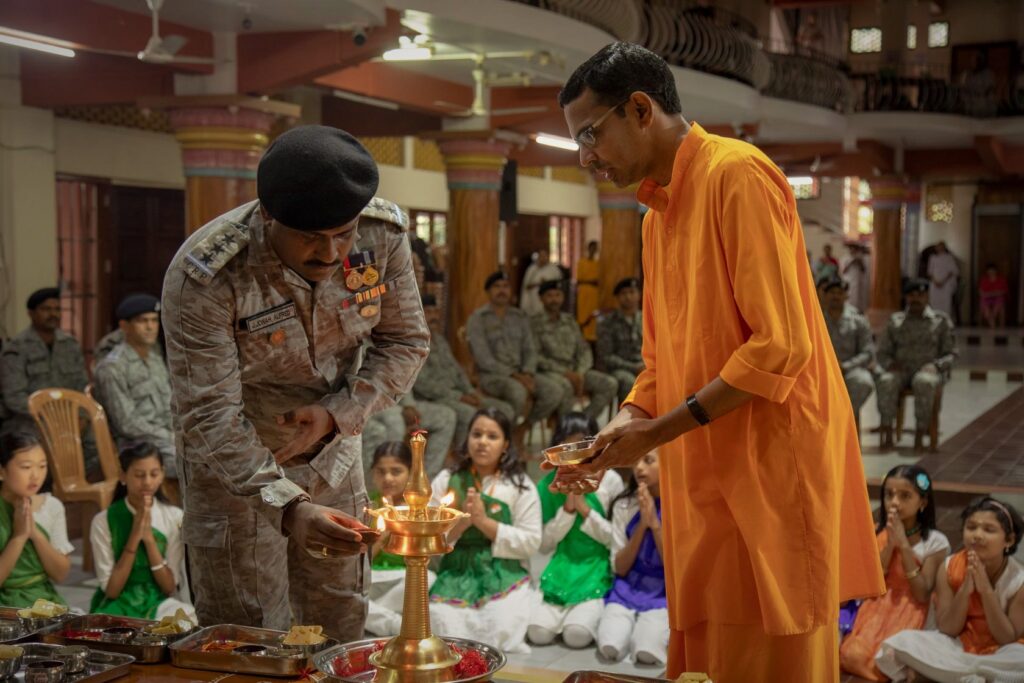 Shubhamrita and a CRPF officer light a lamp