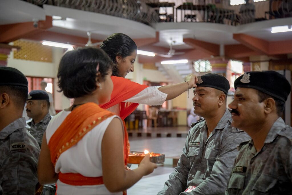 Ashram girls hold light in front of CRPF officers in respect