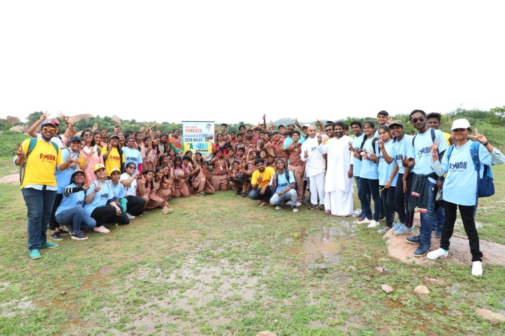 The entire group of students pose for the camera with their seed balls