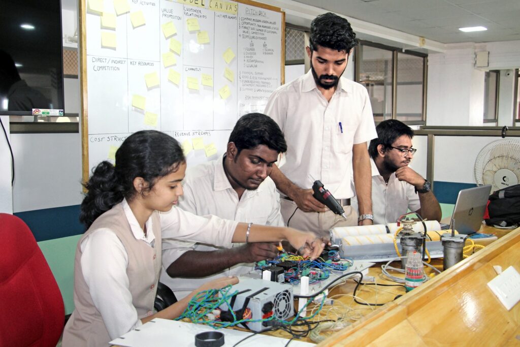 The four students are working in their lab