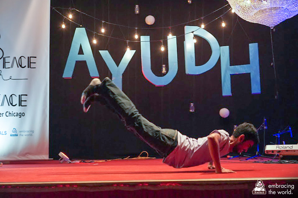 A young AYUDH male is breakdancing on stage