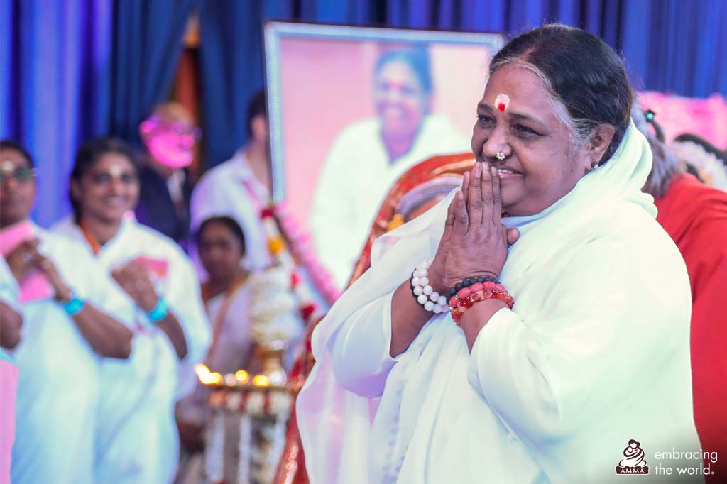 Amma stand with hands in prayer