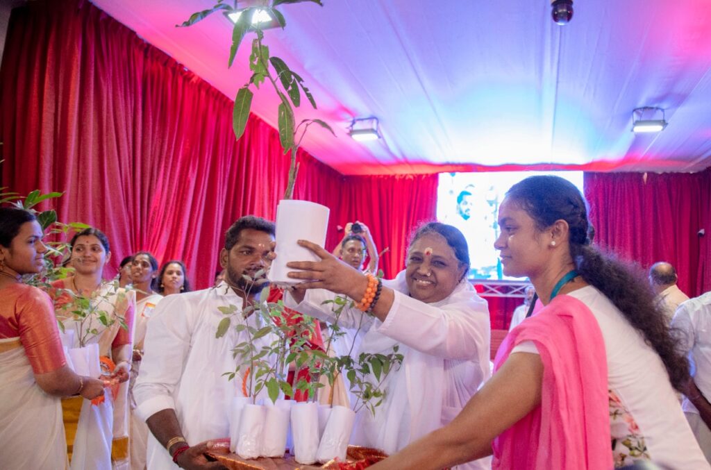 Amma holds up baby plants