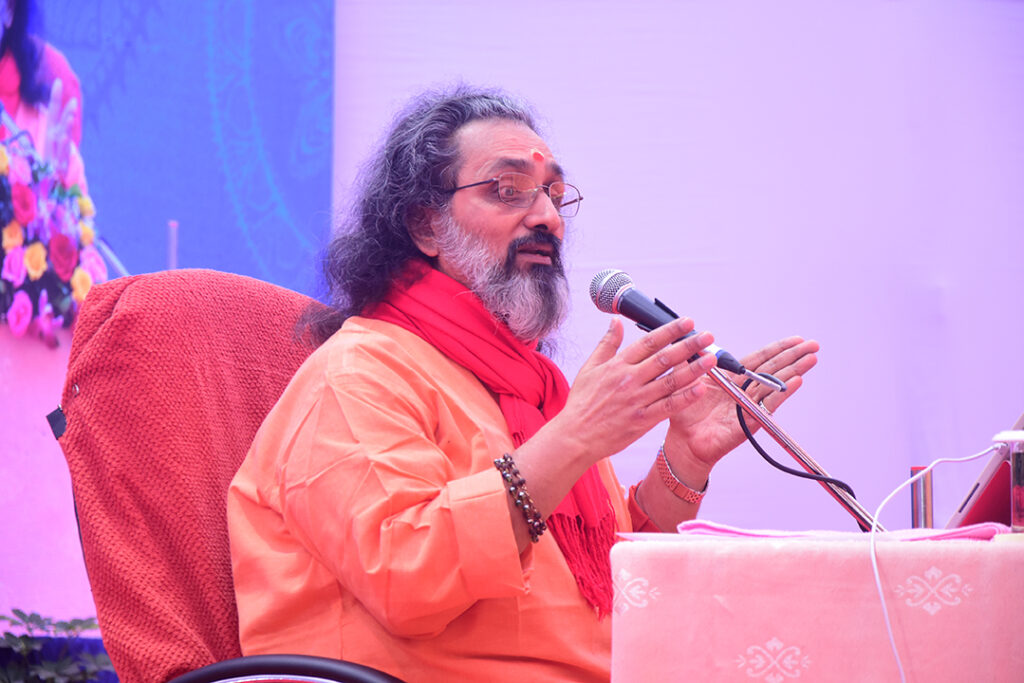 Swami Amritaswarupananda Puri sitting in a chair talking.