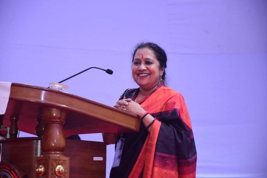 Woman standing at a podium.