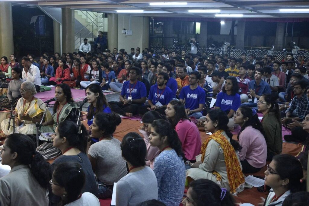 A crowd of people sitting and intently watching something.