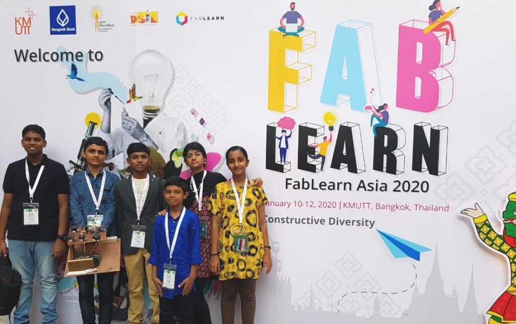 Students stand in front of poster