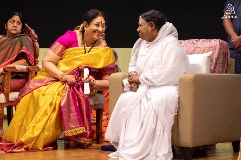Amma and another woman speak