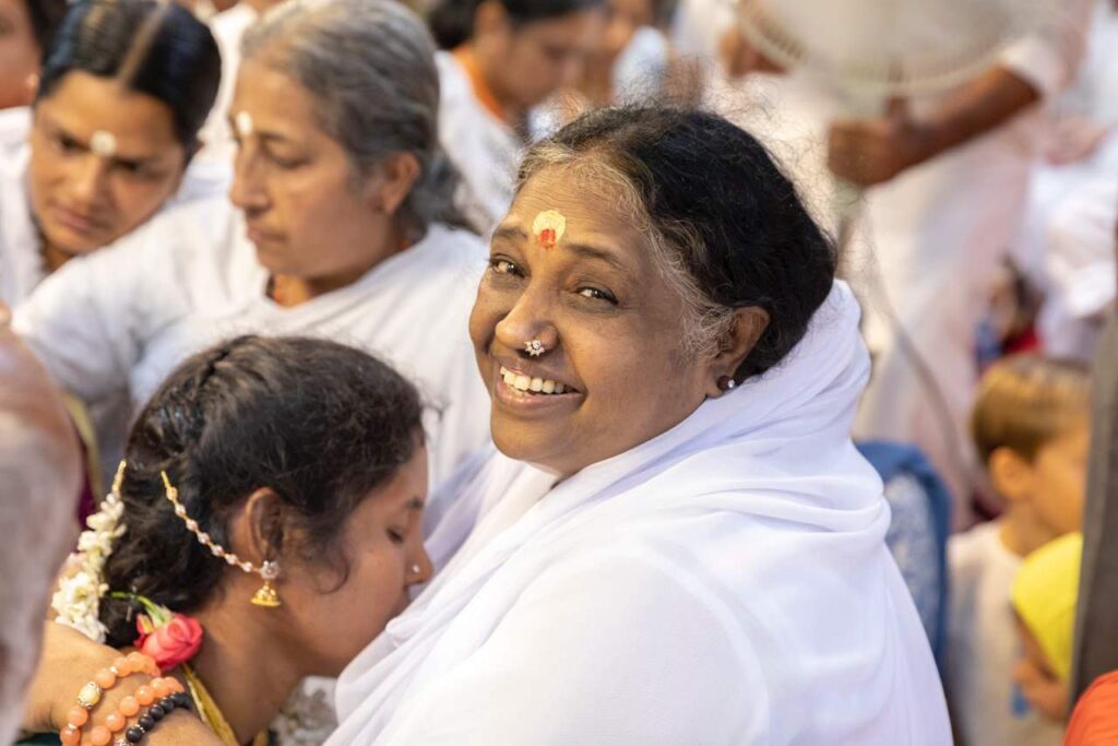 Amma smiles as she gives darshan