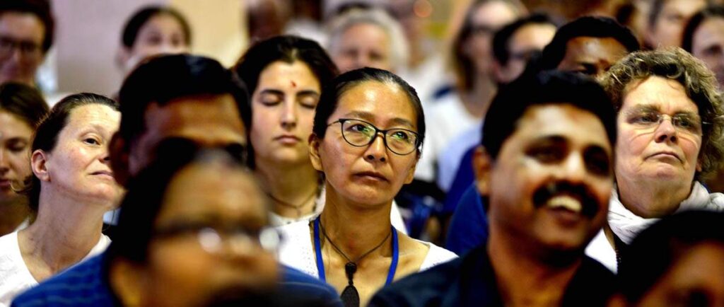 Audience members listen to Amma