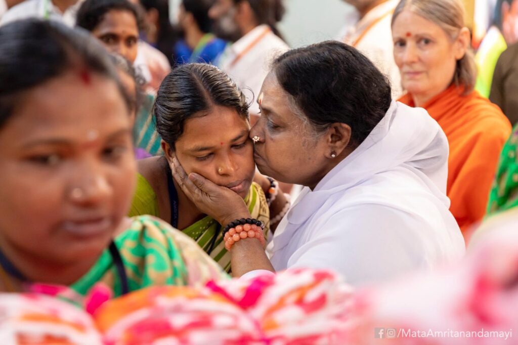 Amma embraces underprivilged women while distributing saris