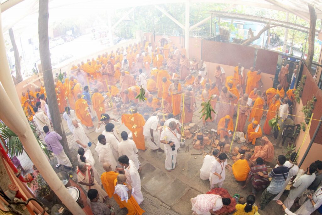 An ariel and smokey view of the rows of fire pits cooking the food offered as alms.