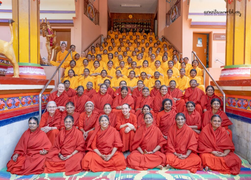 In even rows, up the stairs of the Kali temple in Amritapuri, rows of newly intiated sannyasi and brahmcharya sisters sit.