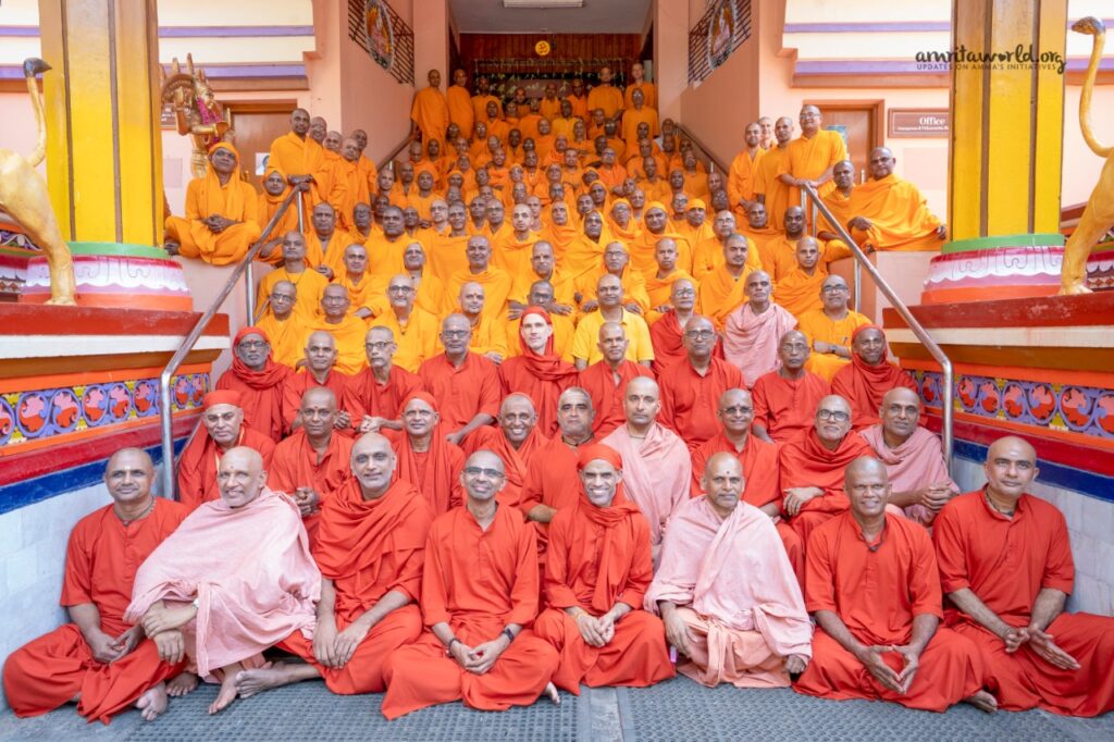 In even rows, up the stairs of the Kali temple in Amritapuri, rows of newly intiated sannyasi and brahmcharya brothers sit.