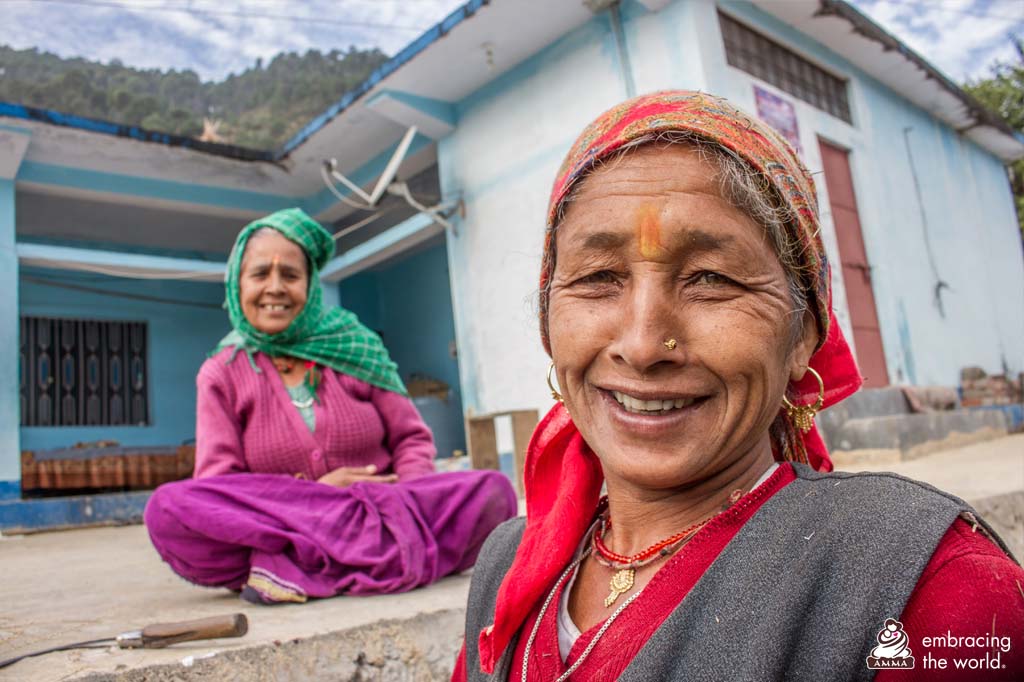 Two elderly village women smile