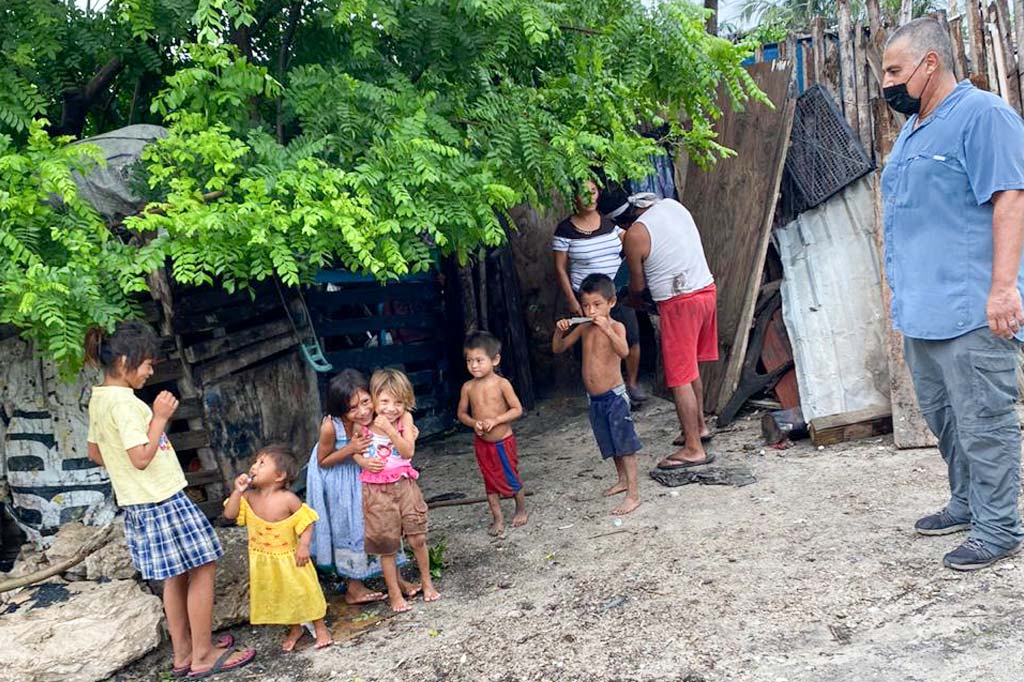 Martinez watches the children in one of the homes they visited.