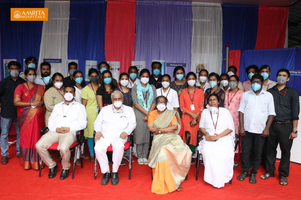 Amrita Hospital staff sit together 