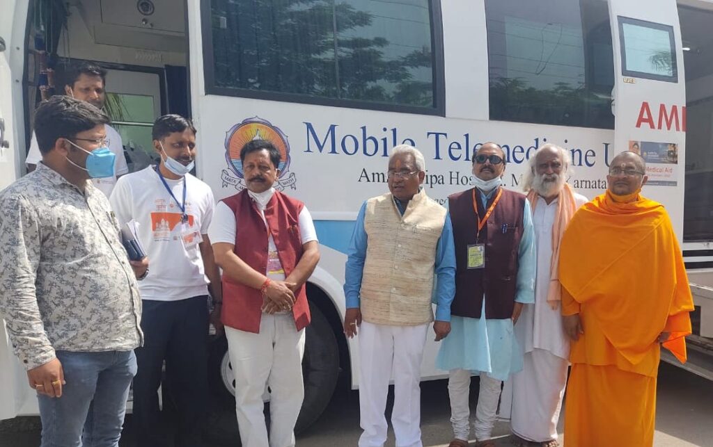 Organizers stand in front of mobile hospital