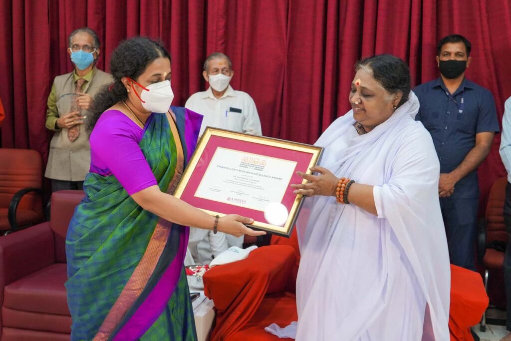 Amma and Dr.Maneesha hold placcard