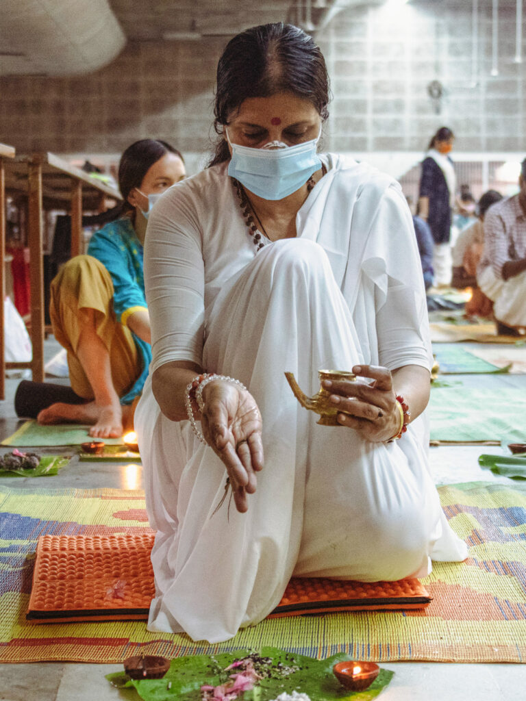 Indian woman offers water as part of the ceremont