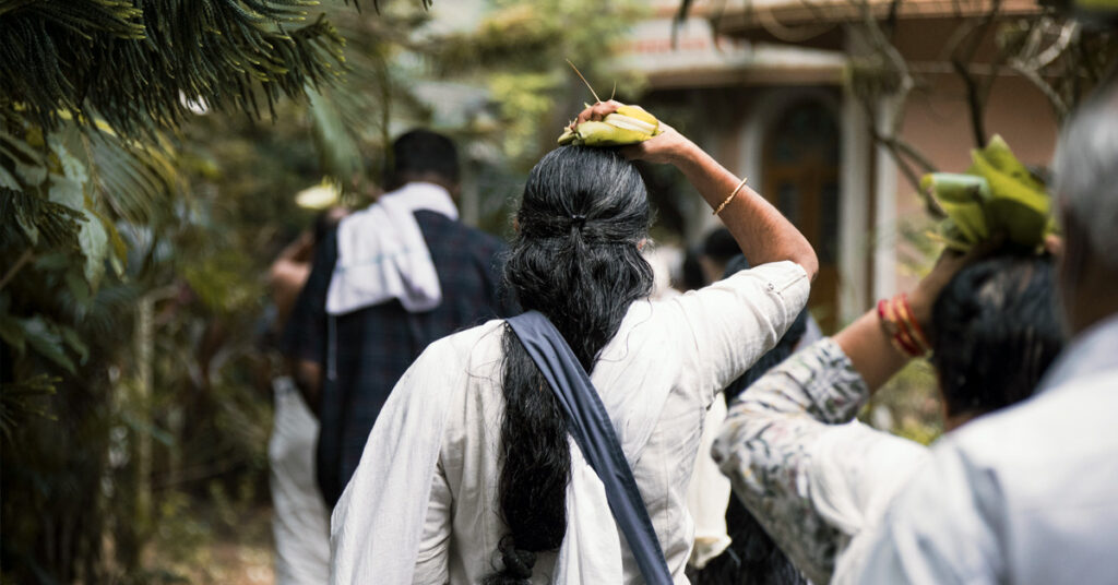 Woman carrying sacraments on her head