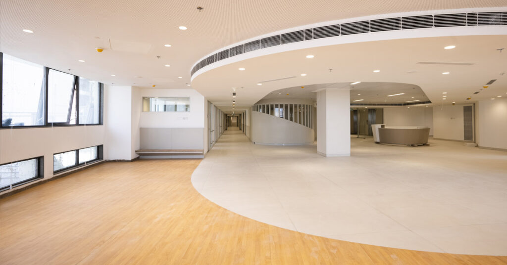 A white semi circle ceiling and windows letting in the light, and a long hallway is seen for paediatric out patient care.