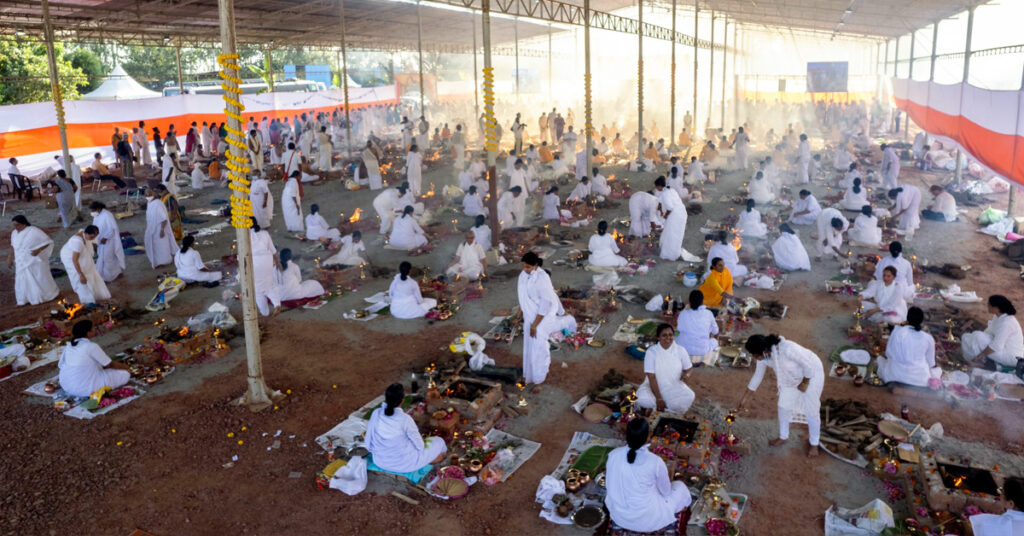 Women sit around ceremonial fire pits