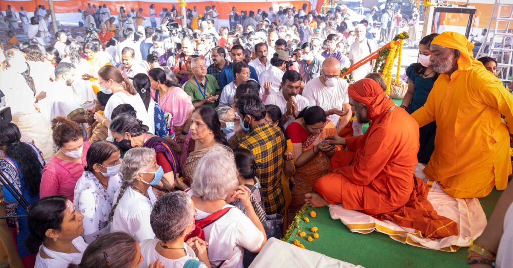 People wait to receive prasad