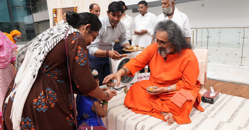 A woman receives prasad